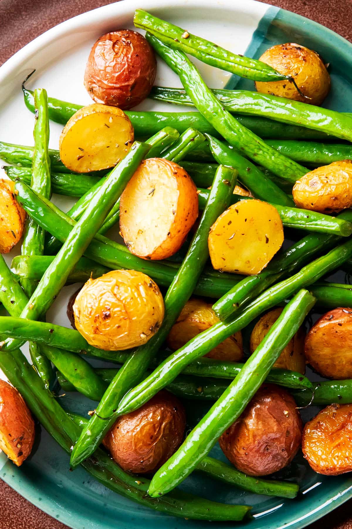 Roasted potatoes and green beans recipe with tender roasted red potatoes and crisp roasted green beans served on a plate.