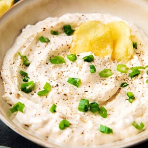 Clam dip recipe with loads of cream cheese, clams, clam juice, and seasonings served in a dip bowl
