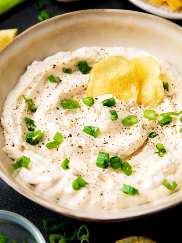 Clam dip recipe with loads of cream cheese, clams, clam juice, and seasonings served in a dip bowl