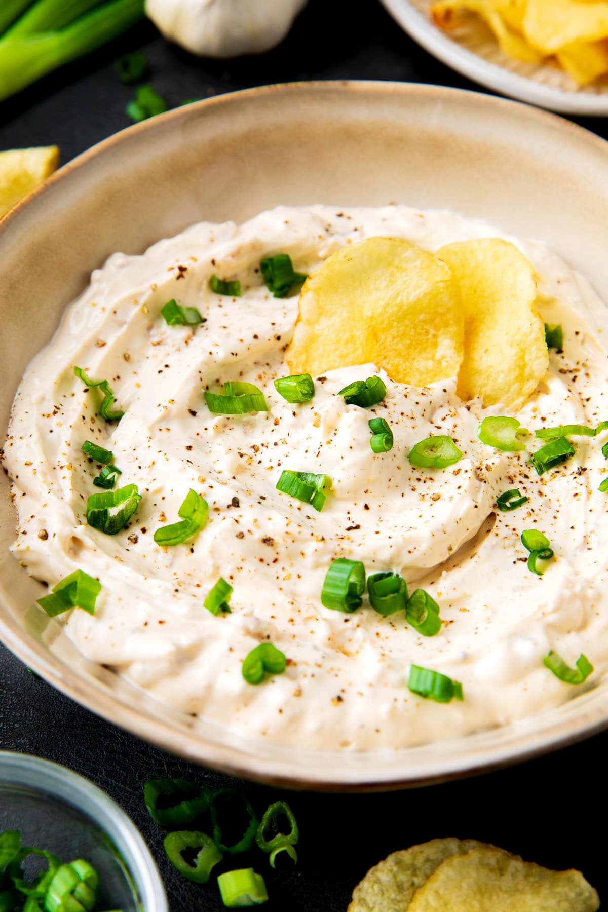 Clam dip recipe with loads of cream cheese, clams, clam juice, and seasonings served in a dip bowl.