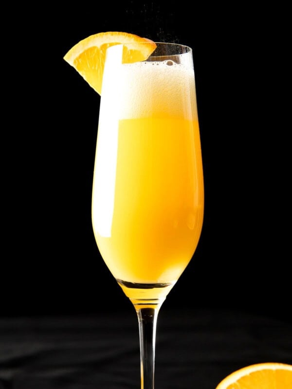 Close up of mimosa recipe with Prosecco with an orange wedge on the champagne rim