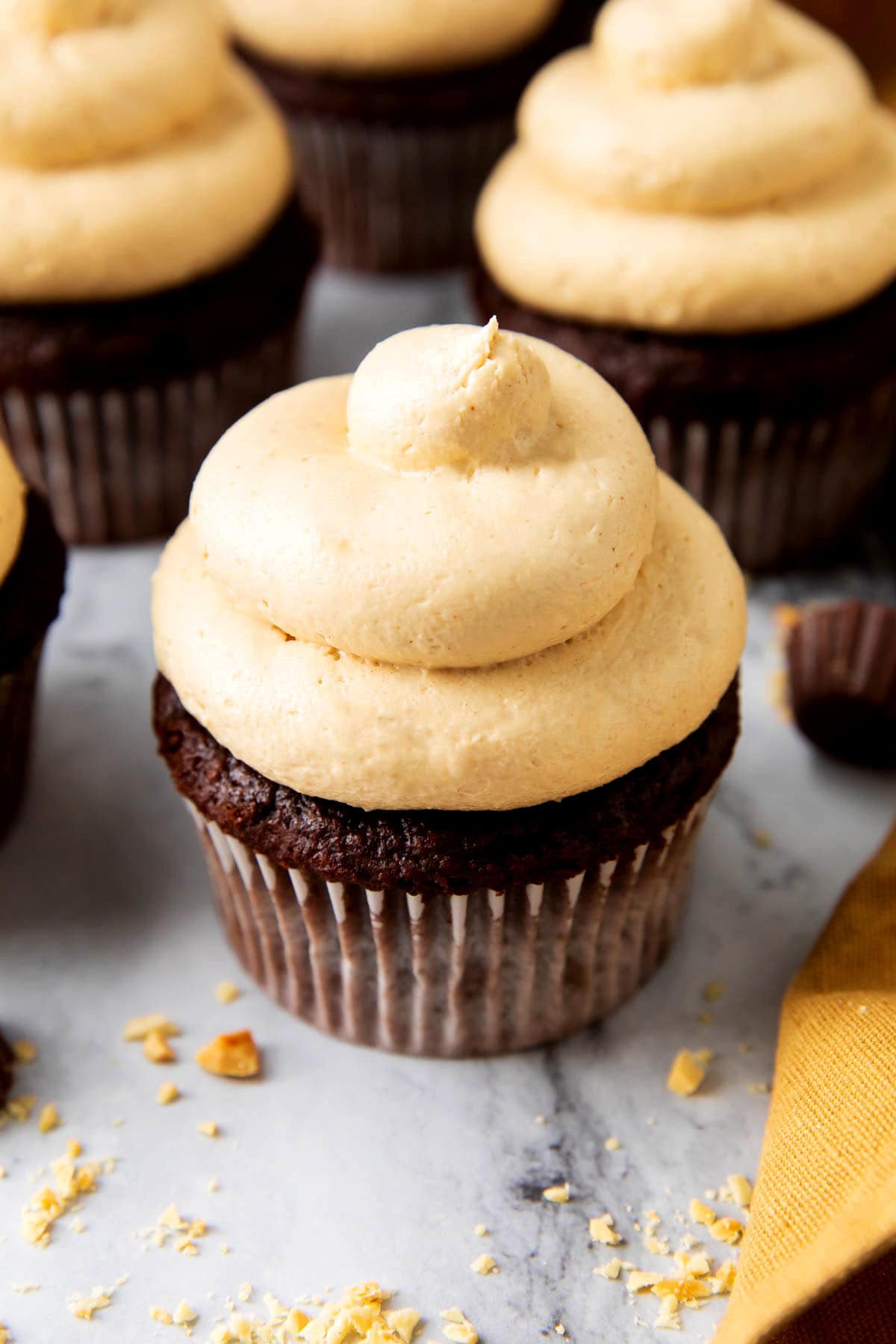 The best homemade easy peanut butter frosting is piped high onto a chocolate cupcake.