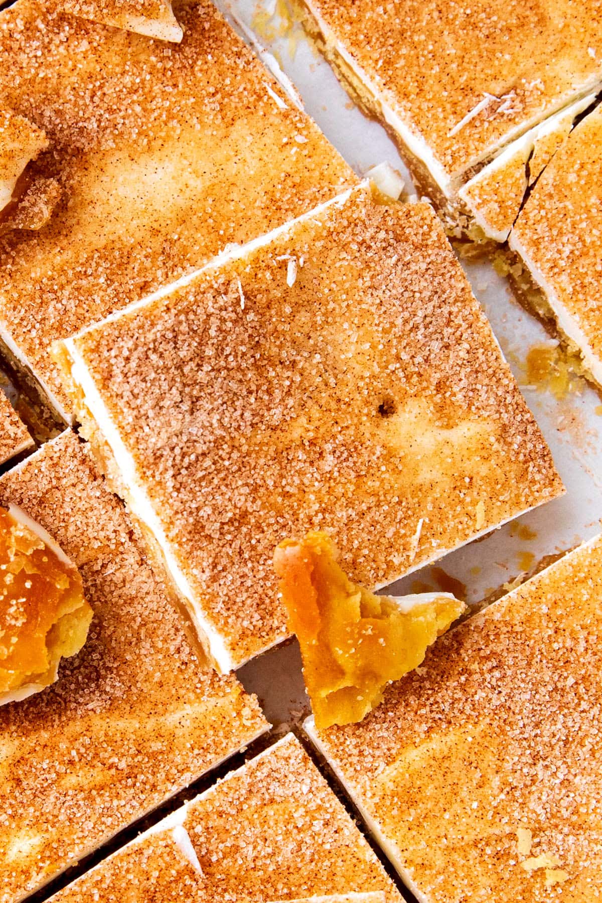 Close up of churro crack shows cinnamon sugar generously coating white chocolate over toffee saltine crackers.