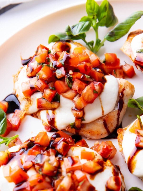 basil and tomato bruschetta on chicken with balsamic glaze on top for an easy chicken dinner recipe