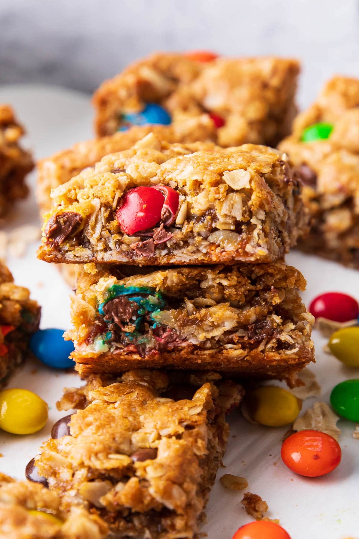 A stack of two Monster Cookie Bars shows the chewy texture from oats, chocolate chips and peanut butter.