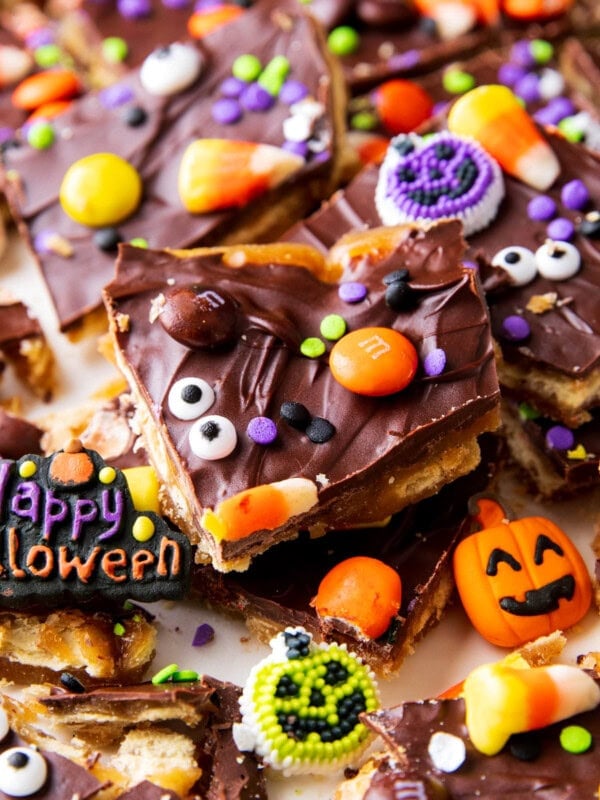 A piece of Halloween Crack has spooky sprinkles, googly eyes, and candy corn on top