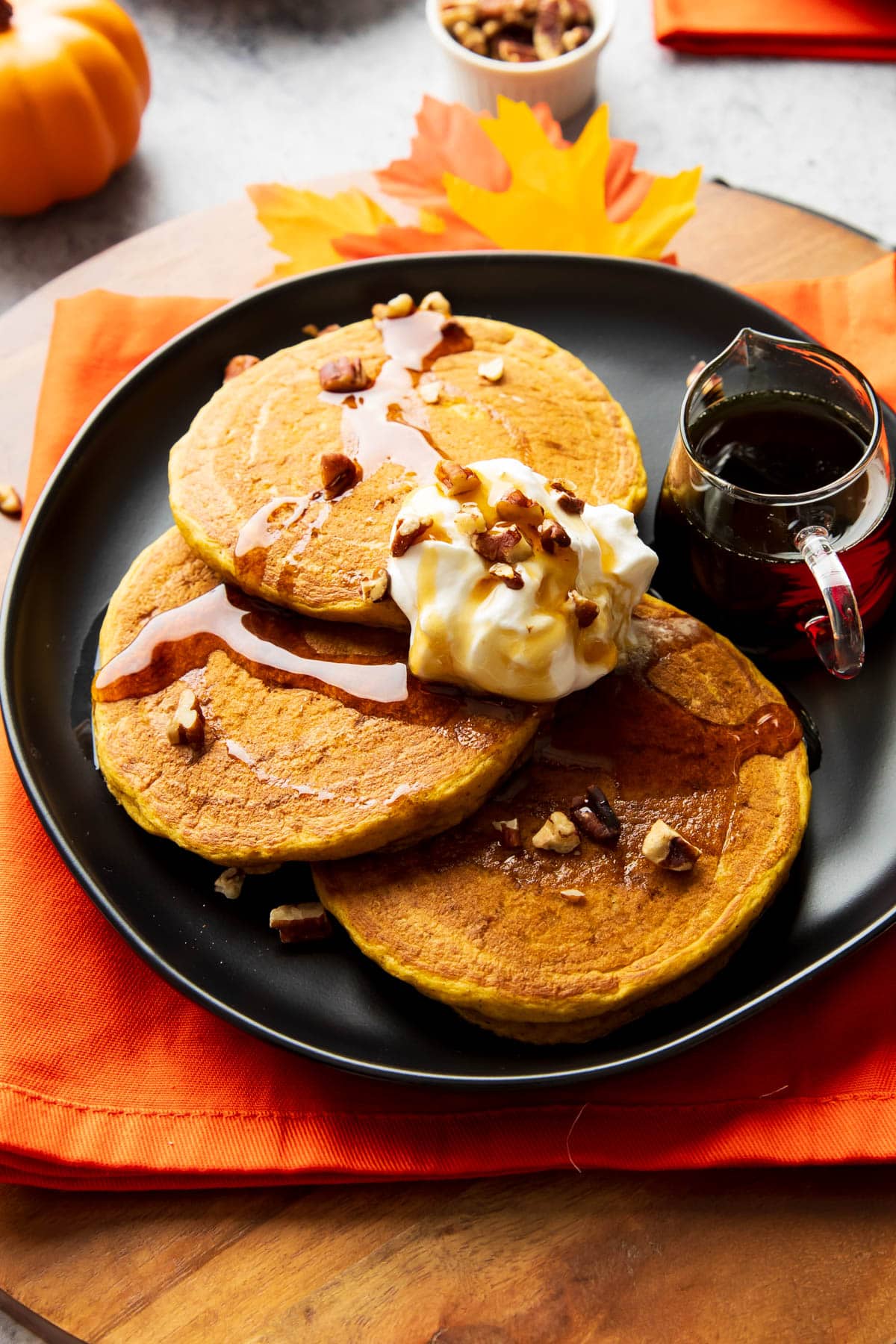 A short stack of Pumpkin Pancakes is packed with pumpkin, pumpkin spice, and a touch of brown sugar and melted butter.
