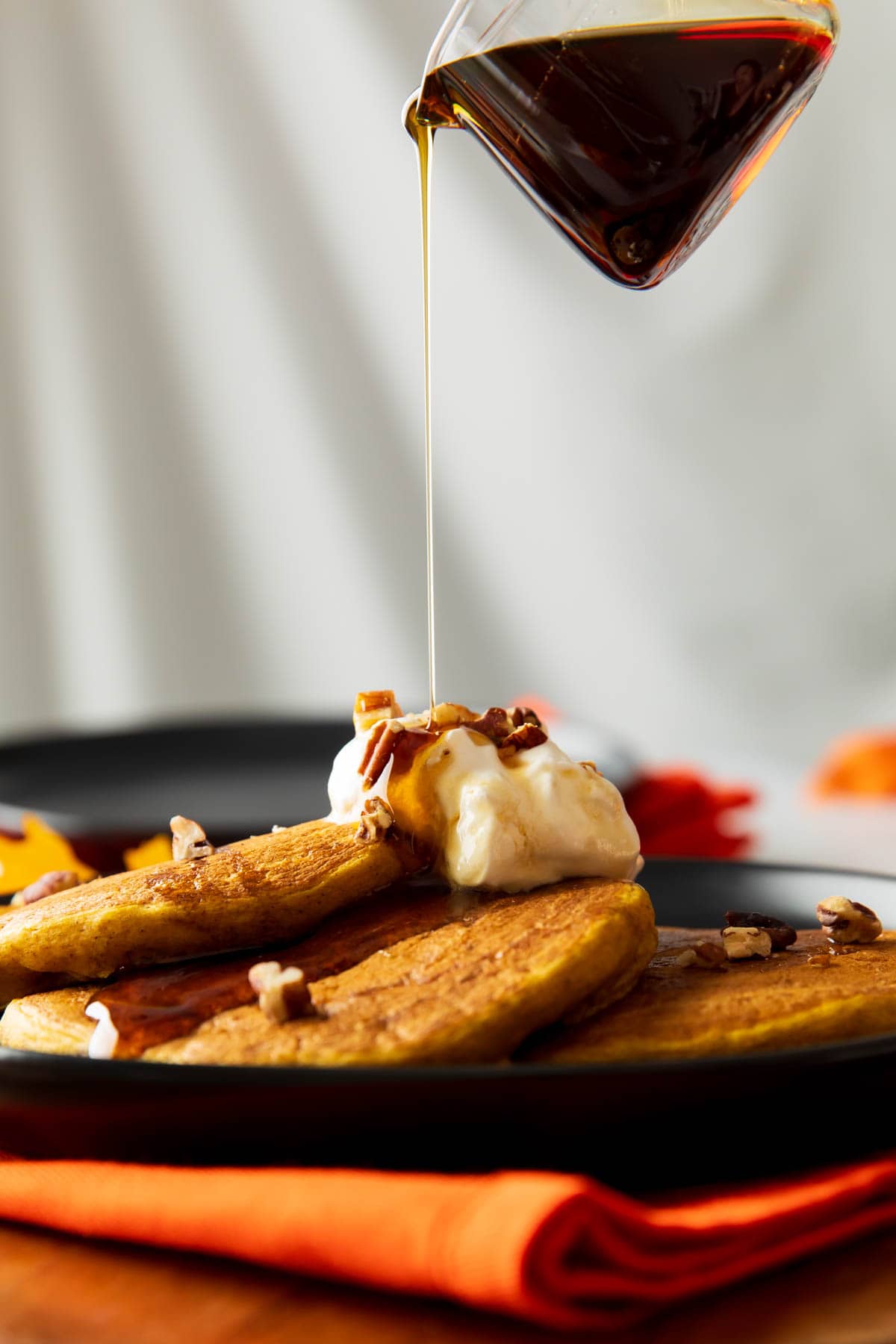 Someone pouring pure maple syrup onto this fall breakfast recipe.