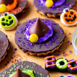 Witch Hat Cookies are overturned fudge-striped cookies topped with frosting and a Hershey's kiss and Halloween sprinkles and sugar