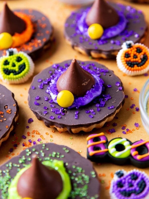 Witch Hat Cookies are overturned fudge-striped cookies topped with frosting and a Hershey's kiss and Halloween sprinkles and sugar