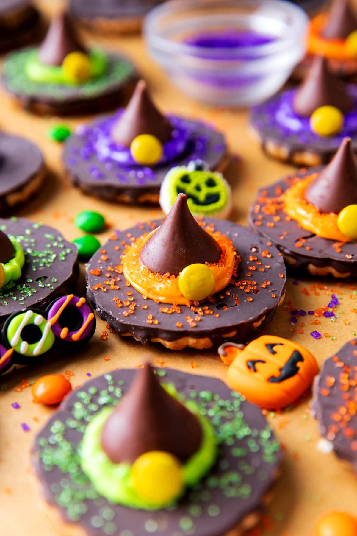 A jack-o-lantern and a Happy Halloween dessert topper sit near a tray of easy no bake treats.