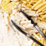 Creamy Parmesan Pasta in a pan with cooked pasta