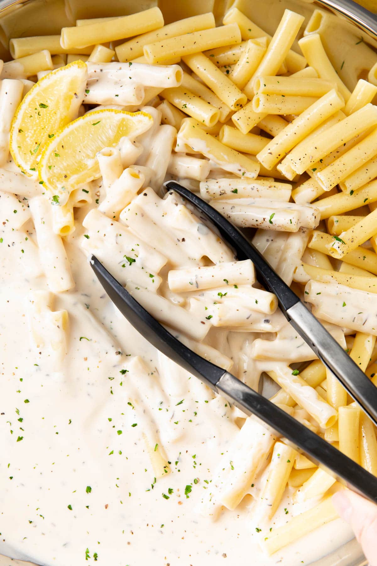 Creamy Parmesan Pasta in a pan with cooked pasta.
