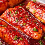 Gochujang salmon is baked in marinade in a pan and broiled until it's honey glazed