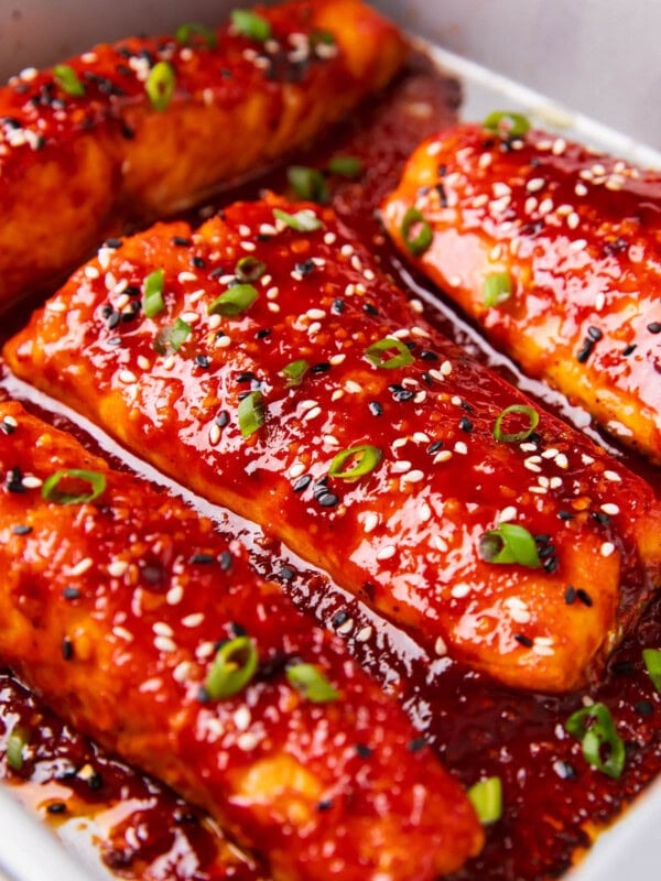 Gochujang salmon is baked in marinade in a pan and broiled until it's honey glazed