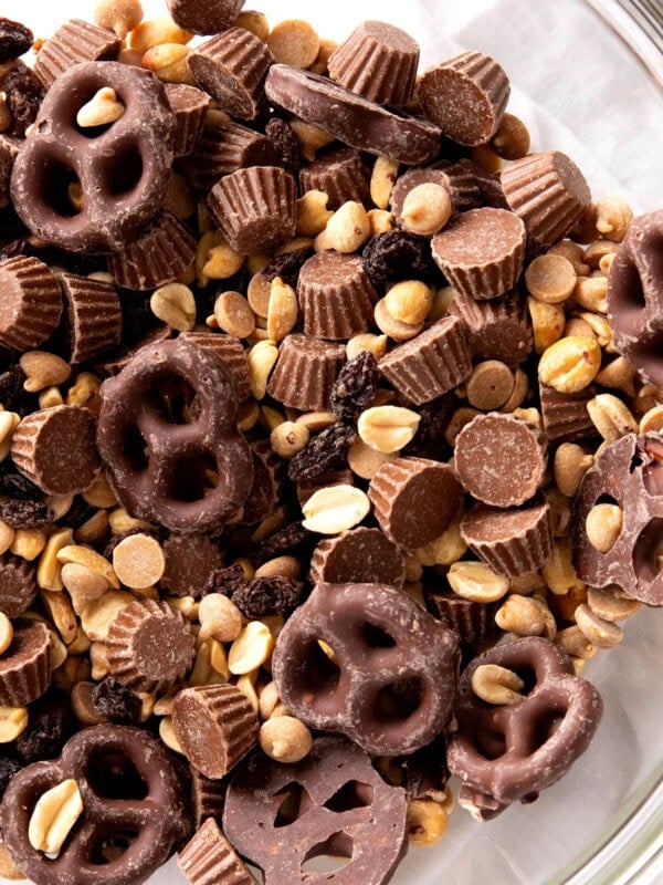 Close up of peanut butter cup trail mix shows delicious textured ingredients including salty peanuts, sweet peanut butter cups, milk chocolate covered pretzels and more.